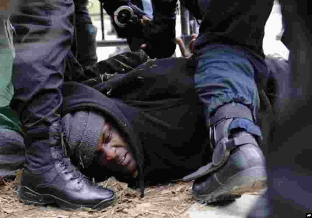 U.S. National Park Service police take a protester into custody as they clear out the Occupy DC encampment in McPherson Square in Washington February 4, 2012.