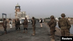 U.S. troops and Afghan security force arrive at the site of a suicide car bomb attack in Kandahar province. (file) Al-Harbi coordinates those who fight Coalition forces in Afghanistan. 