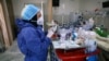 In this Tuesday, June 16, 2020, photo, a nurse prepares medicines for COVID-19 patients at the Shohadaye Tajrish Hospital in Tehran, Iran. After months of fighting the coronavirus, Iran only just saw its highest single-day spike in reported cases…