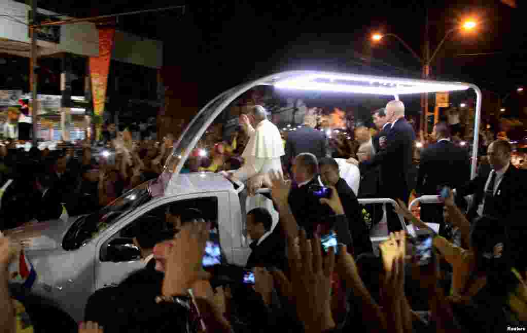 Pope Francis arrives at Ycua Bolanos supermarket, where more than 300 people died in a fire in 2004, in Asuncion, July 12, 2015.