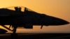 FILE - A fighter jet maneuvers on the deck of the USS Dwight D. Eisenhower in the Red Sea, June 11, 2024. 