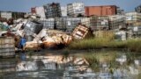 FILE - Containers used for hazardous chemicals lie exposed in a junkyard run by the Chinese-led Dar Petroleum Operating Co., near Paloch, South Sudan, Oct. 1, 2018. 