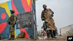 Government soldiers and police officers, at right, who surrendered to M23 rebels, left, board trucks to an undisclosed location in Goma, Democratic Republic of Congo, on Jan. 30, 2025.