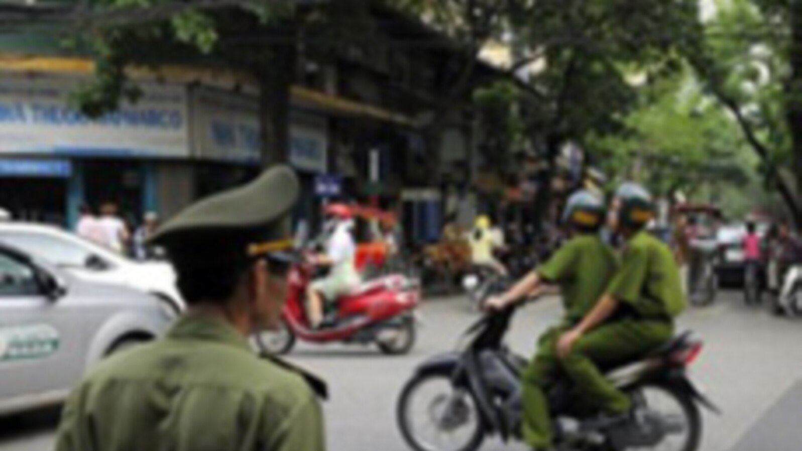 Policemen on motorcycle in Hanoi, Vietnam, June 11, 2010