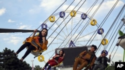 Visitors enjoy a ride at Kabul City Park in Kabul, Afghanistan, July 24, 2020. 