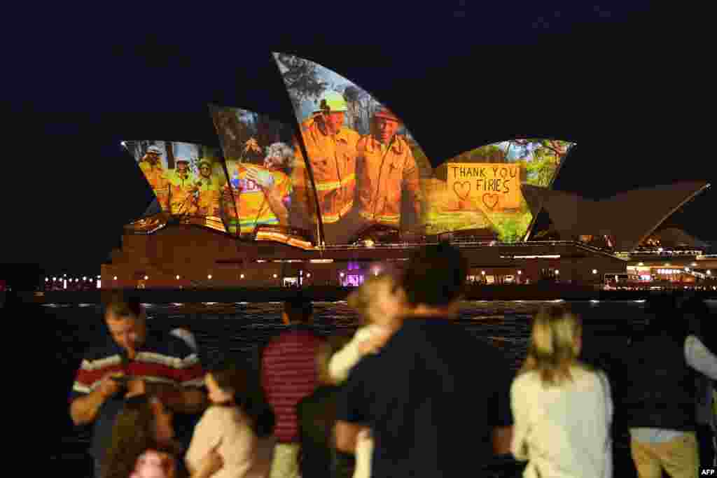 The sails of the Opera House are lit with a series of images to show support for the communities affected by the bushfires and to express the gratitude to the emergency services and volunteers in Sydney, Australia, Jan. 11, 2020.
