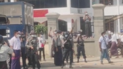 Police officers hold riffles as they continue to disperse protesters outside the No. 1 Basic Education High School, in Myawaddy, Myanmar, Feb. 7, 2021 in this still image obtained from a video.