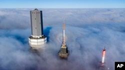 Telekom devices are surrounded by clouds on top of the Feldberg mountain near Frankfurt, Germany.