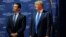 FILE - Then U.S. Republican presidential candidate Donald Trump welcomes his son Donald Trump Jr. to the stage at one of the New England Council's "Politics and Eggs' breakfasts in Manchester, New Hampshire, Nov. 11, 2015.