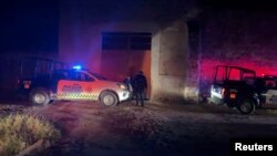 Vehículos y agentes policiales fuera del lugar donde un grupo armado abrió fuego a participantes de una fiesta en Salvatierra, Guanajuato.