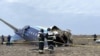 Emergency specialists work at the crash site of an Azerbaijan Airlines passenger plane near the city of Aktau, Kazakhstan, Dec. 25, 2024. (Kazakhstan Emergencies Ministry/Handout via Reuters)