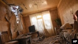 Damage is seen inside an apartment in a residential area after shelling during a military conflict in the self-proclaimed Republic of Nagorno-Karabakh, Stepanakert, Azerbaijan, Oct. 3, 2020. 
