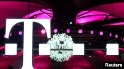 FILE - Deutsche Telekom logo is seen during preparations at the CeBit computer fair in Hanover, Germany.