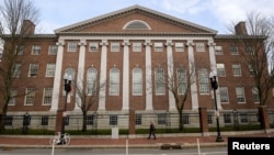 FILE - An unidentified person walks past Harvard yard at Harvard University in Cambridge, Massachusetts, December 7, 2023 