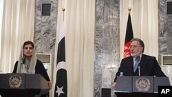 Pakistan Foreign Minister Hina Rabbani Khar, left, speaks during a joint press conference with her Afghan counterpart Zalmai Rasool at the foreign ministry in Kabul, Afghanistan, February 1, 2012.