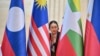 A police official looks on between national flags during the Association of Southeast Asian Nations summit in Vientiane, Laos, on Oct. 9, 2024. One topic of discussion for the ASEAN representatives will be proposed additions to the group's free-trade agreement with China.