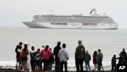 Historic Arctic Cruise: This Aug. 21, 2016, photo shows people preparing to take a polar plunge in the Bering Sea in front of the luxury cruise ship Crystal Serenity, which anchored just outside Nome, Alaska. The ship made a port call as it became the largest cruise ship to ever go through the Northwest Passage, en route to New York City.