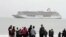 FILE - People prepare to take a polar plunge in the Bering Sea in front of the luxury cruise ship Crystal Serenity, which anchored just outside Nome, Alaska, Aug. 21, 2016. The ship made a port call as it became the largest cruise ship to ever go through the Northwest Passage, en route to New York City.