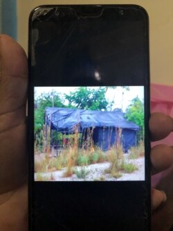 FILE - A resident displays a photo on her phone of the tents where she said the guerrillas sleep, near the Colombian border, outside Puerto Ayacucho, Amazonas, Venezuela Dec. 2, 2020.