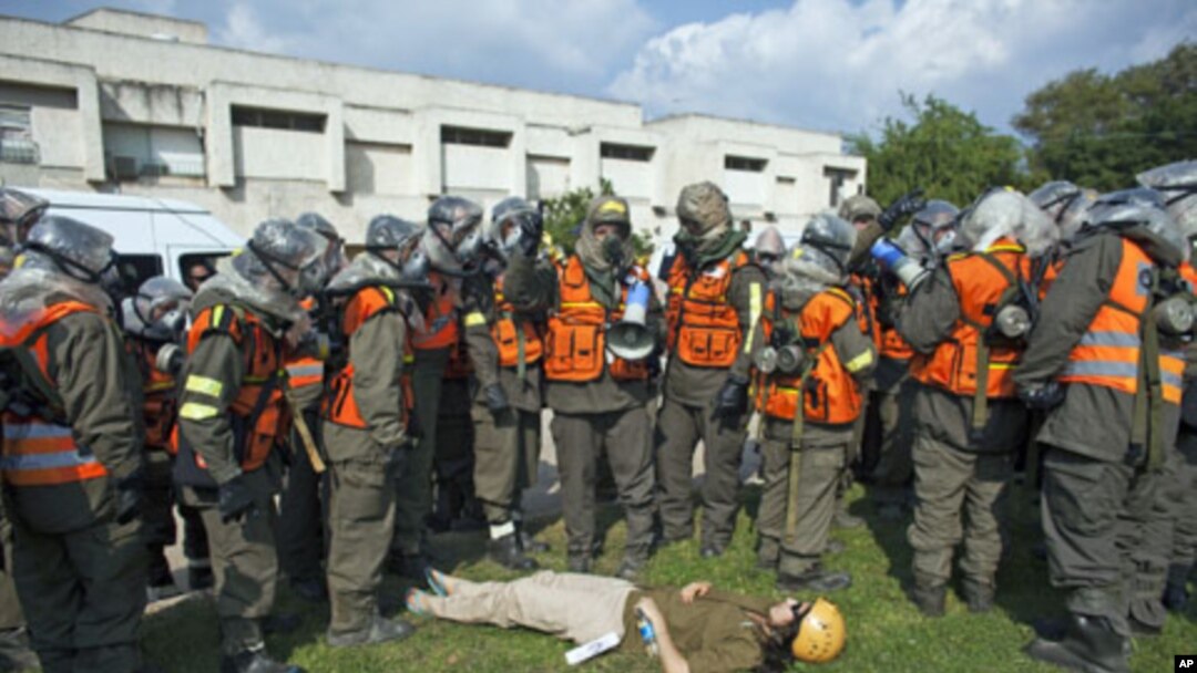 An Israeli soldier role playing as a mock victim lies on the ground during a drill simulating a missile attack in Holon near Tel Aviv November 3, 2011.