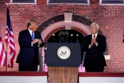 FILE - Vice President Mike Pence, right, stands on stage with President Donald Trump after Pence spoke on the third day of the Republican National Convention at Fort McHenry National Monument and Historic Shrine in Baltimore, Maryland, Aug. 26, 2020.