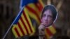 A demonstrator holds a cut-out of Catalonia's ex-president Carles Puigdemont during a protest outside Catalonia's parliament in Barcelona, Spain, Jan. 30, 2018. 