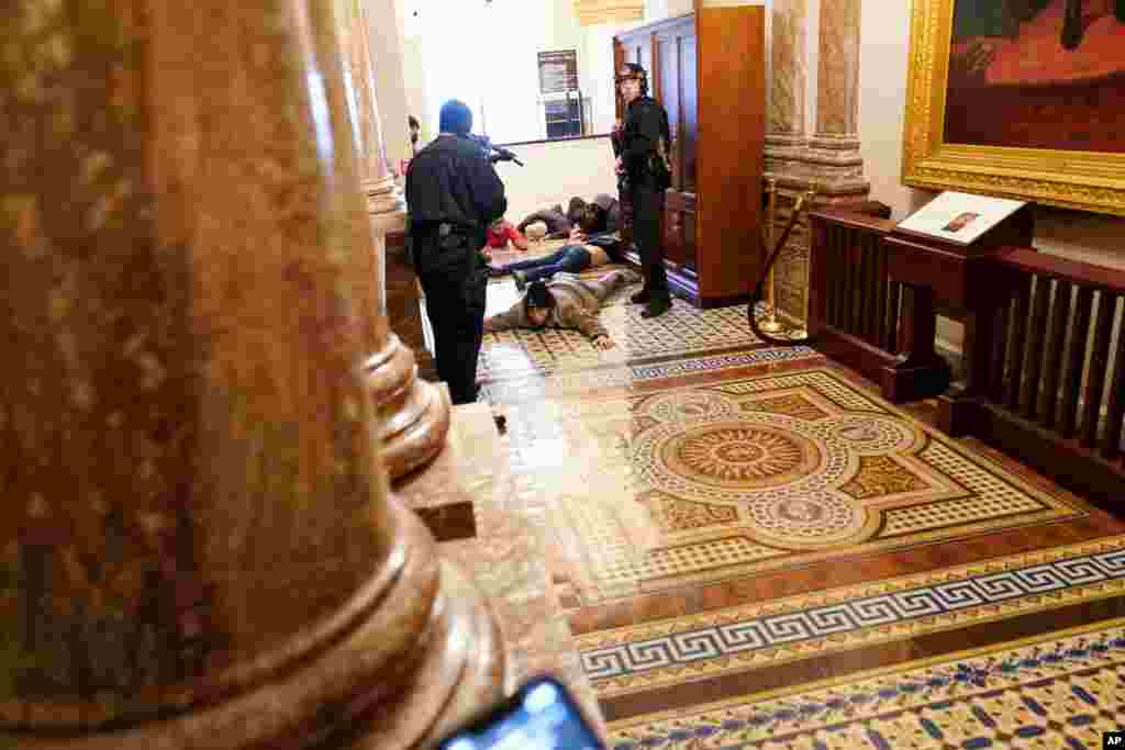 U.S. Capitol Police hold protesters at gun-point near the House Chamber inside the Capitol in Washington.