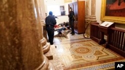U.S. Capitol Police hold protesters at gun-point near the House Chamber inside the Capitol, Jan. 6, 2021, in Washington.