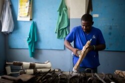 Prosthetic technician Wilfrid Macena works in a workshop at the St. Vincent's Center, an institution run by Haiti's Episcopal Church in downtown Port-au-Prince, June 4, 2019.