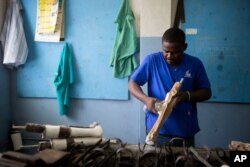 Prosthetic technician Wilfrid Macena works in a workshop at the St. Vincent's Center, an institution run by Haiti's Episcopal Church in downtown Port-au-Prince, June 4, 2019.
