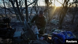A Ukrainian serviceman uploads shells in a tank, amid Russia's attack on Ukraine, in Luhansk region, Ukraine, Feb. 18, 2024. 
