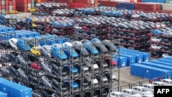 Cars are stacked ready to be loaded onto a ship for export at the port in Taicang, in China’s eastern Jiangsu province on July 16, 2024.