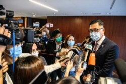 FILE - Pro-democracy lawmaker Lam Cheuk-ting, right, speaks to reporters in Hong Kong, Nov. 12, 2020.
