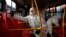 Des employées colombiennes désinfectant un bus à la gare routière de Bogota, afin de prévenir la propagation du nouveau coronavirus, 15 mars 2020. (Photo AFP/Raul Arboleda)