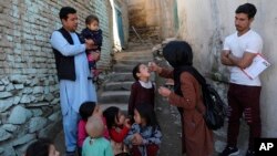 FILE - A health worker administers a polio vaccine to a child in Kabul, Afghanistan, March 29, 2021. 