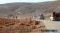 FILE - This image posted online on Saturday, Dec. 10, 2016, by supporters of the Islamic State militant group on an anonymous photo sharing website, purports to show a convoy of vehicles of IS driving in a desert area of east of Palmyra city, in Homs, Syr