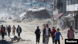 FILE—Palestinians inspect destroyed residential buildings, after the Israeli military withdrew most of its ground troops from the southern Gaza Strip, amid the ongoing conflict between Israel and Hamas, in Khan Younis, in the southern Gaza Strip April 7, 2024.