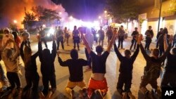 Demonstrators kneel before police May 30, 2020, in Minneapolis, Minnesota.