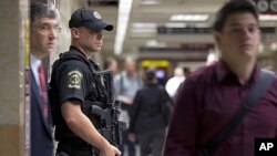 An Amtrak police officer stands guard at a track entrance at Pennsylvania Station in New York, on September 9, 2011.