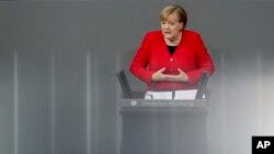German Chancellor Angela Merkel delivers a speech in the German federal parliament, Bundestag in Berlin, Nov. 27, 2019.