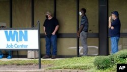 FILE - Job seekers line up outside the Mississippi Department of Employment Security WIN Job Center in Pearl, Mississippi, Aug. 31, 2020.