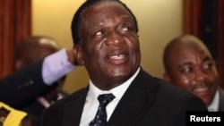 Newly appointed Zimbabwean Deputy President Emmerson Mnangagwa smiles at the headquarters of ZANU (PF) in Harare, Dec.10, 2014. 