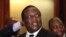 FILE - Zimbabwean Deputy President Emmerson Mnangagwa smiles at the headquarters of ZANU (PF) in Harare, Dec.10, 2014. 