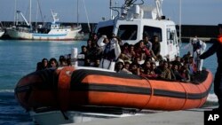 Migrants and refugees enter in the port of Roccella Jonica, Calabria region, southern Italy, Nov. 14, 2021.