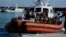 Migrants and refugees enter in the port of Roccella Jonica, Calabria region, southern Italy, Nov. 14, 2021.