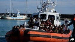 Migrants and refugees enter in the port of Roccella Jonica, Calabria region, southern Italy, Nov. 14, 2021.