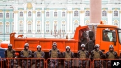 Russian Rosguardia (National Guard) soldiers block entrance to the Palace Square a day before a planned protest in St. Petersburg, Russia, Jan. 30, 2021.