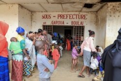 FILE - Refugees from the Central African Republic wait in line in front of the administrative offices in Garoua-Boulai, Cameroon, Jan. 8, 2021.
