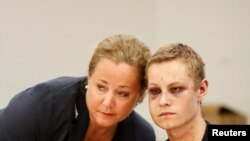 FILE - Philip Manshaus, who is suspected of an armed attack at Al-Noor Islamic Centre Mosque and killing his stepsister appear in court with his lawyer in Oslo, Aug. 12, 201.