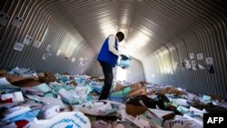 A staff member of the World Food Program (WFP) examines on Aug. 18, 2016 the remains of the logistic base of the United Nations (UN) organization in the Jebel district in Juba, after it was looted during clashes between Government and opposition forces between July 8 and July 11. 